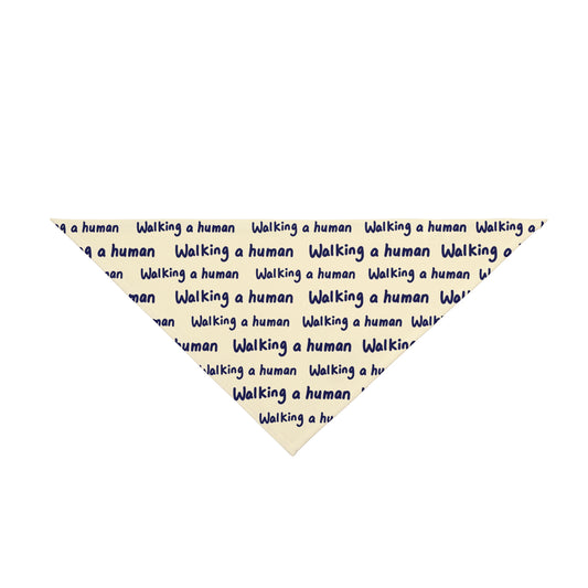 beige "walking a human" repeating text bandana on a small dog