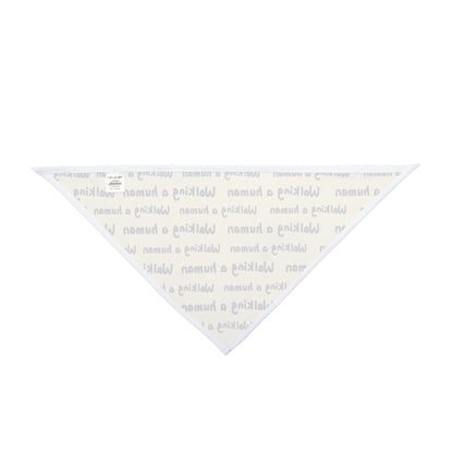 beige "walking a human" repeating text bandana on a small dog