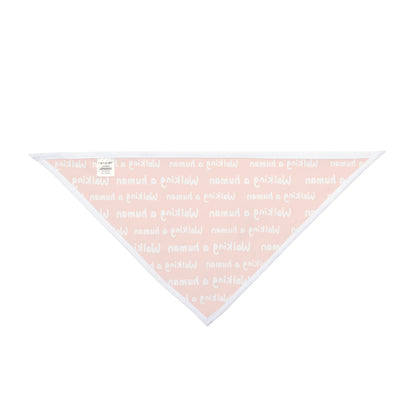 orange "walking a human" repeating text bandana on a dog