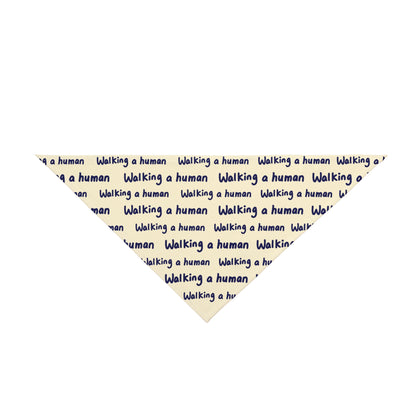 beige "walking a human" repeating text bandana on a small dog