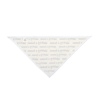 beige "walking a human" repeating text bandana on a small dog