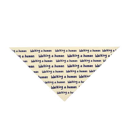 beige "walking a human" repeating text bandana on a small dog