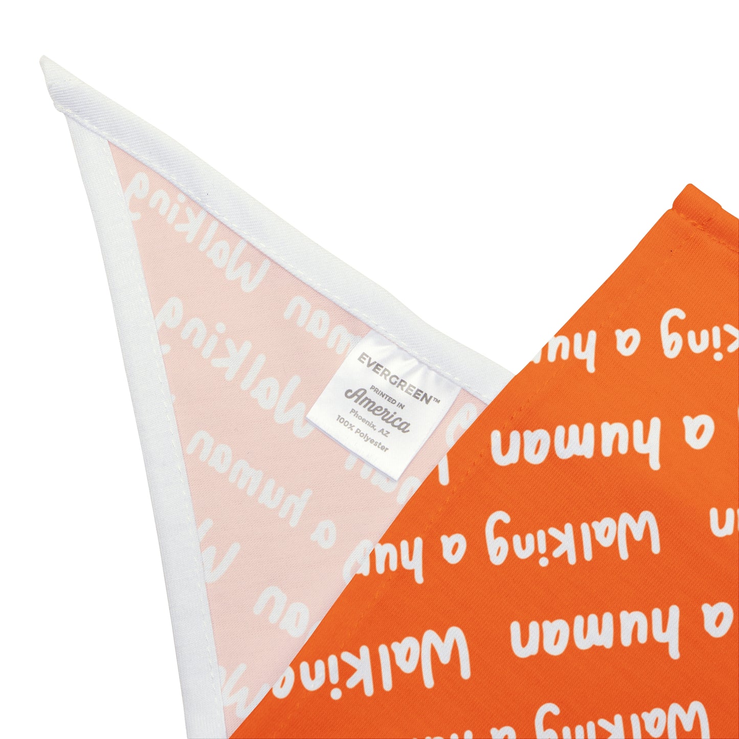 orange "walking a human" repeating text bandana on a dog