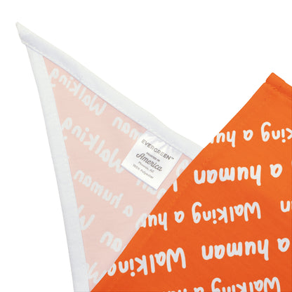 orange "walking a human" repeating text bandana on a dog