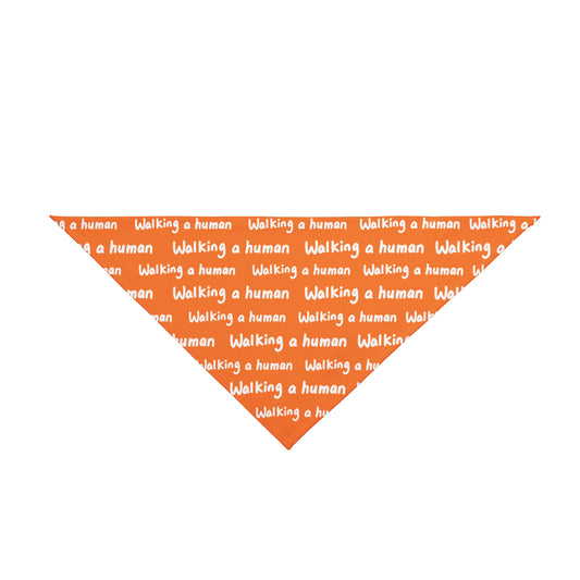 orange "walking a human" repeating text bandana on a dog